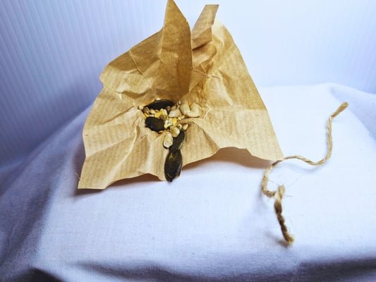 The inside of a hamster easter egg showing that it's filled with seeds and tied with jute twine.
