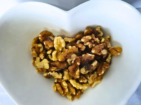 Plain walnut pieces presented in a heart-shaped bowl