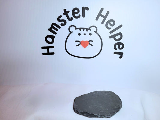 A slate used for hamster nail maintenance in front of the hamster helper logo.