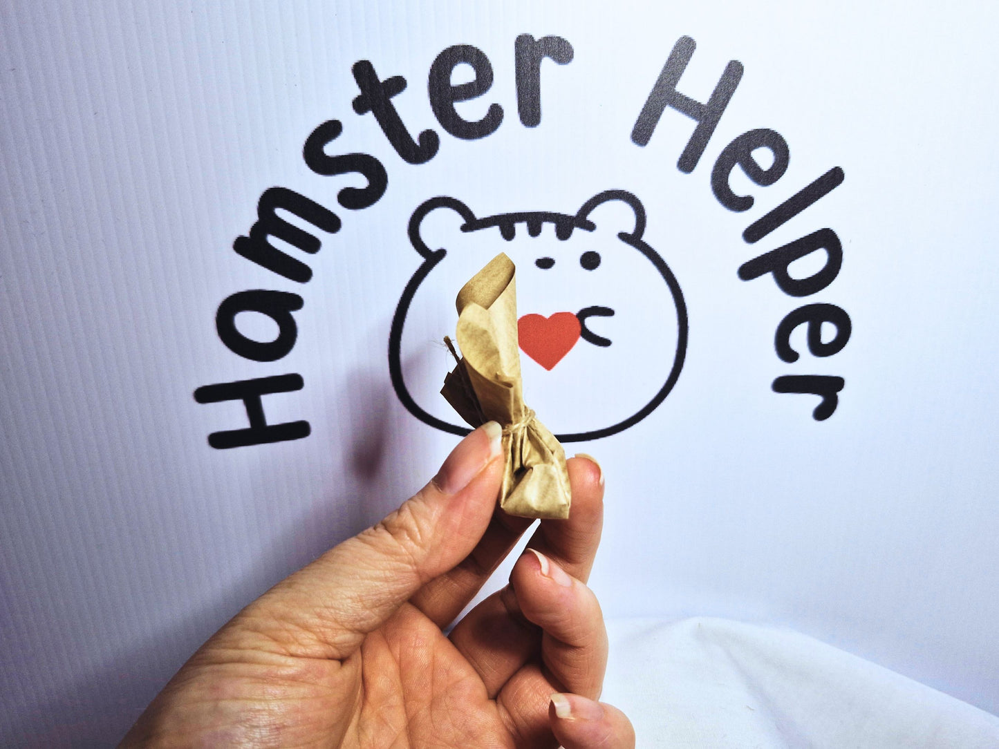 A hand holding a hamster Easter Egg to show  what sort of size they are.