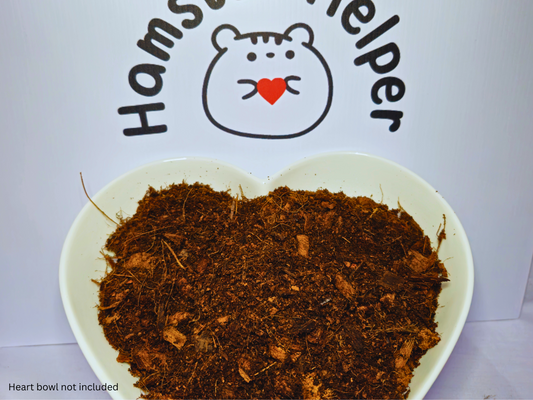 A hart shaped bowl containing hamster safe textured soil in front of the Hamster Helper logo