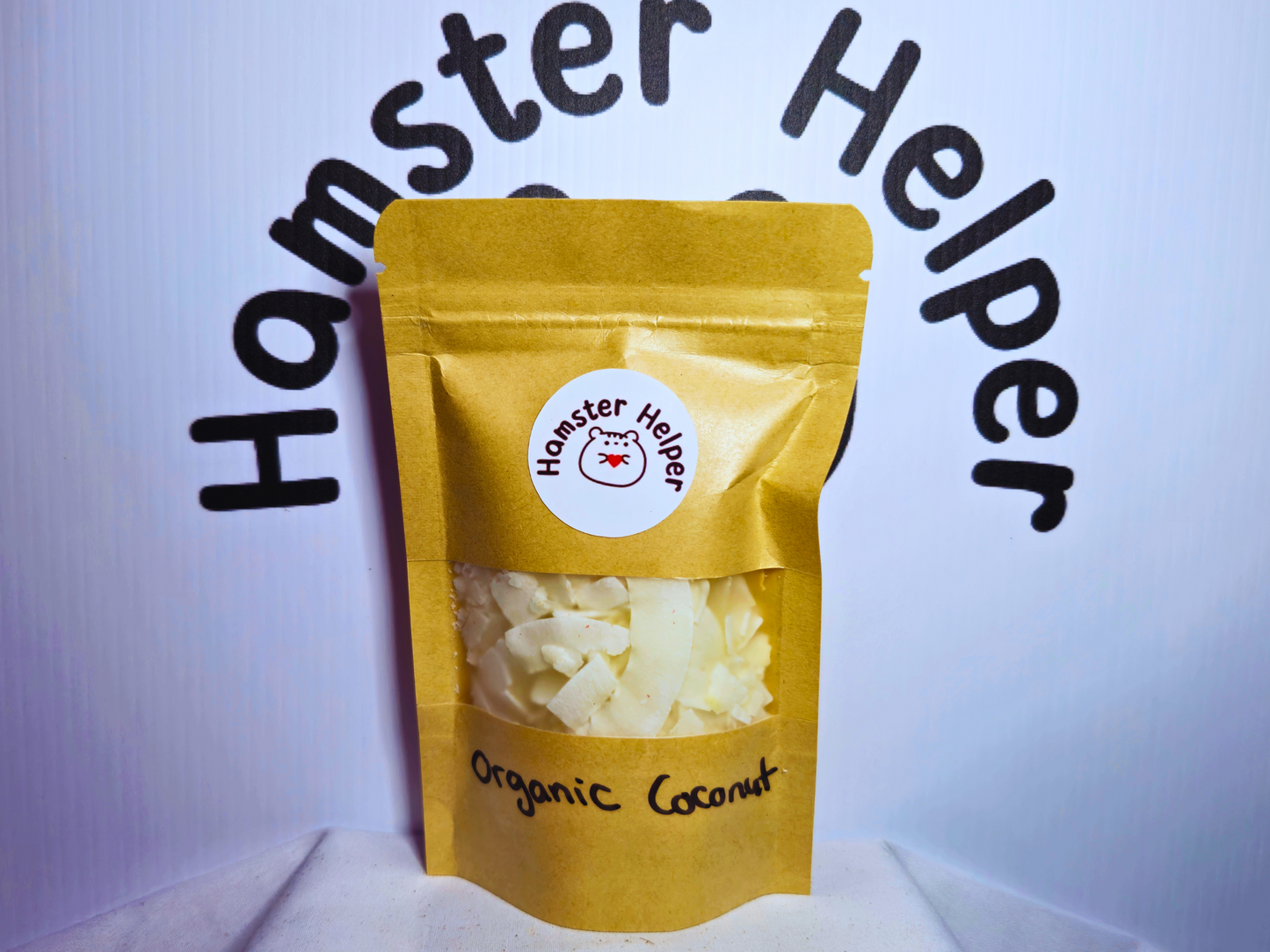 Organic flaked coconut for hamsters in a food pouch with the Hamster Helper logo on it.