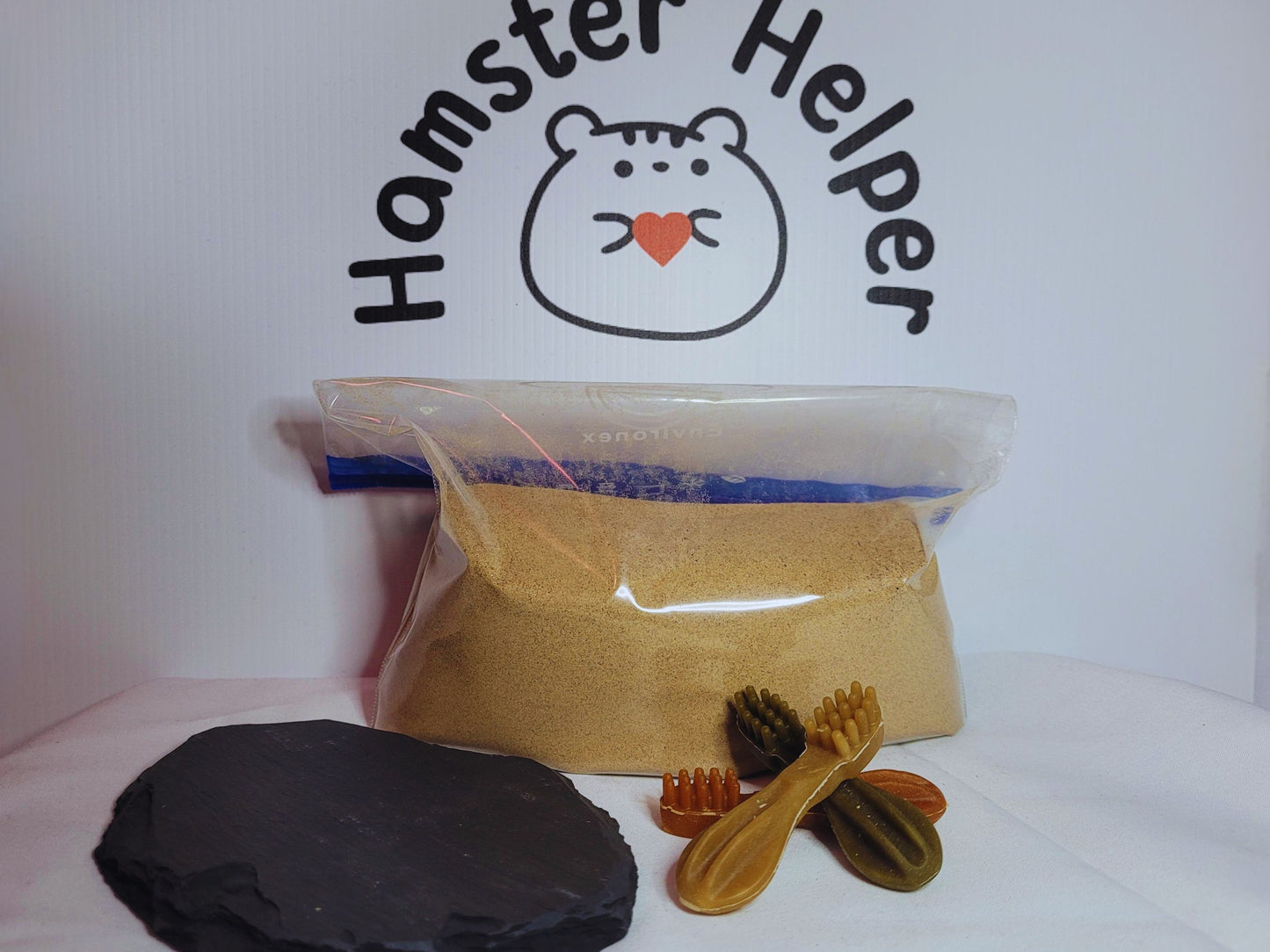 The large hamster grooming bundle containing a large slate, 1kg of sand in a ziplock bag, three whimzee chews