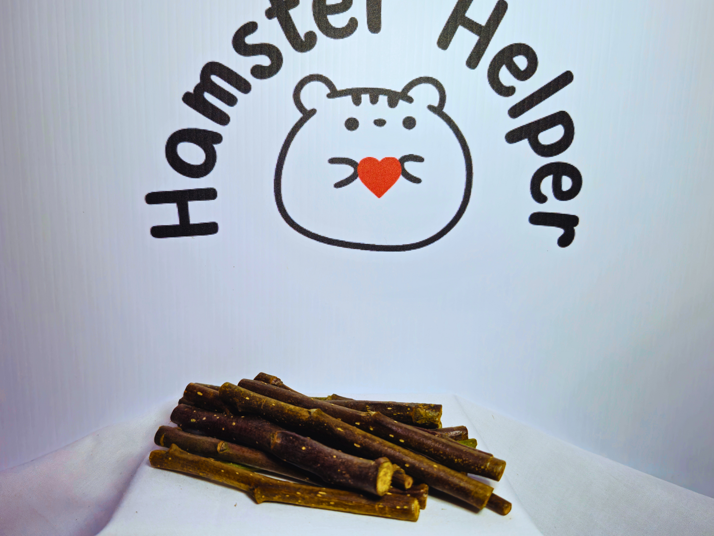 50g of hamster safe organic apple wood chews in front of the Hamster Helper logo.