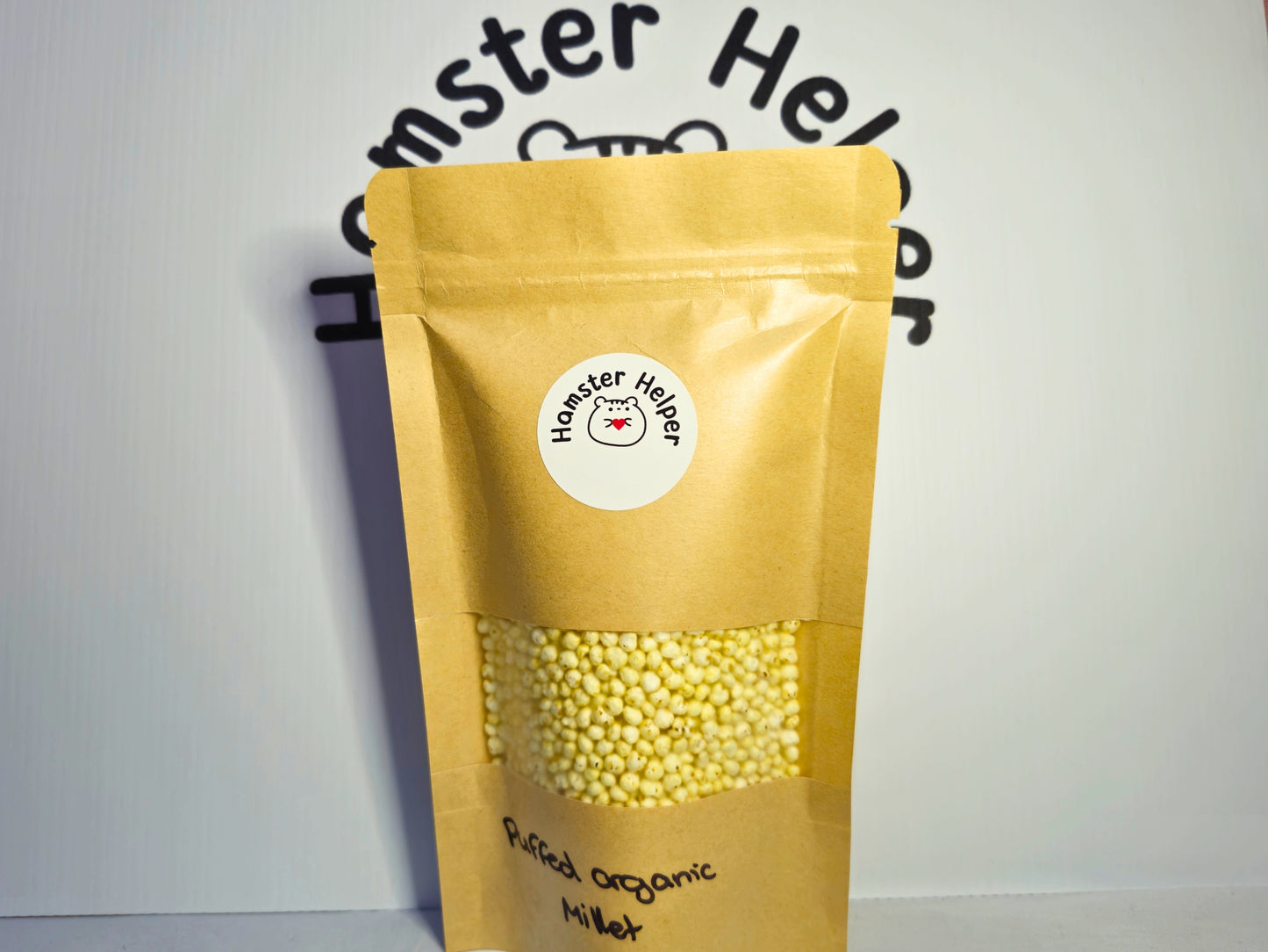 A large pouch of hamster safe puffed organic millet with the Hamster Helper logo on it.