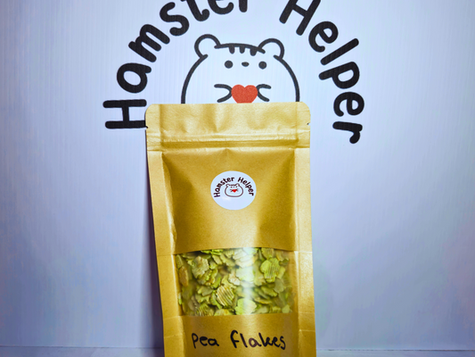 A picture of some hamster safe pea flakes in a re-sealable bag placed in front of the hamster helper logo