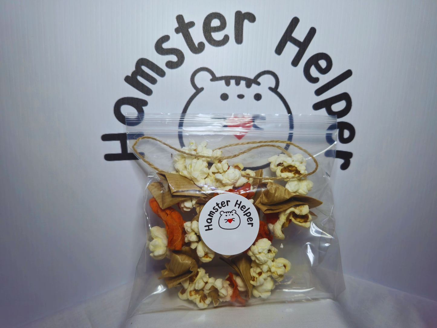 The hamster chewy garland in a plastic bag with the Hamster Helper logo on it showing the pacakging.