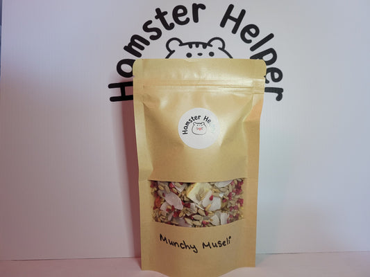 The munchy museli hamster treat mix in a pouch with the hamster helper logo on it.