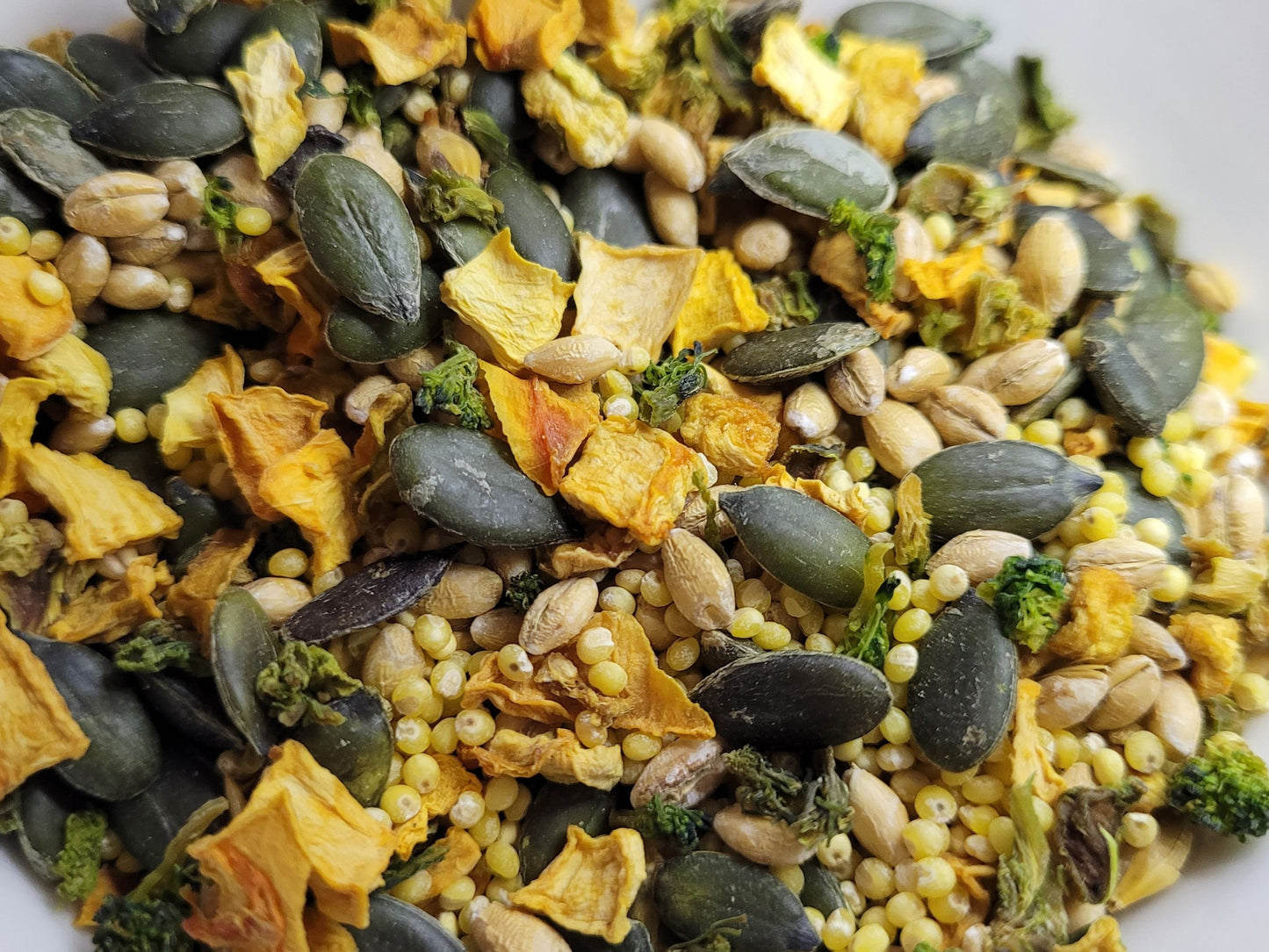 A close up of the very veggie treat mix containing dried vegetables, grains and seeds.