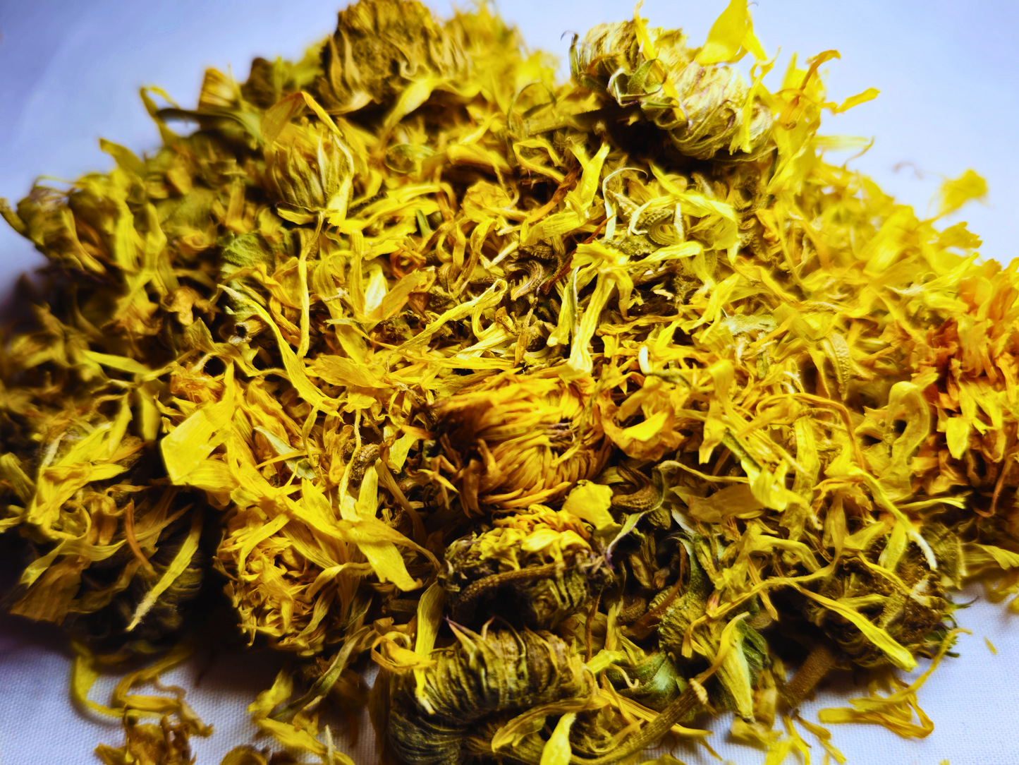 A close up of hamster safe dried marigold heads.