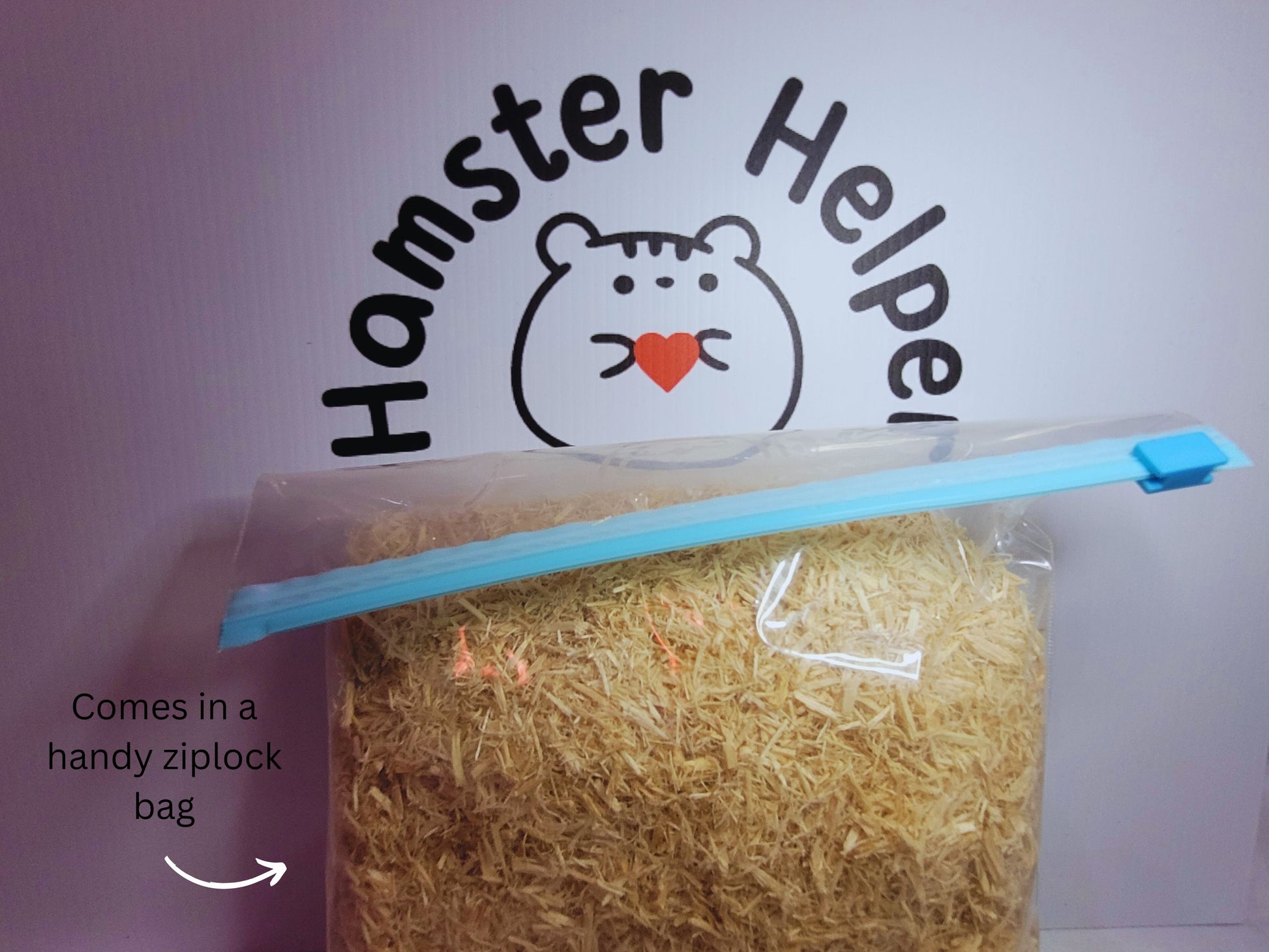 A ziplock bag full of hamster safe aspen displayed in front of the Hamster Helper logo