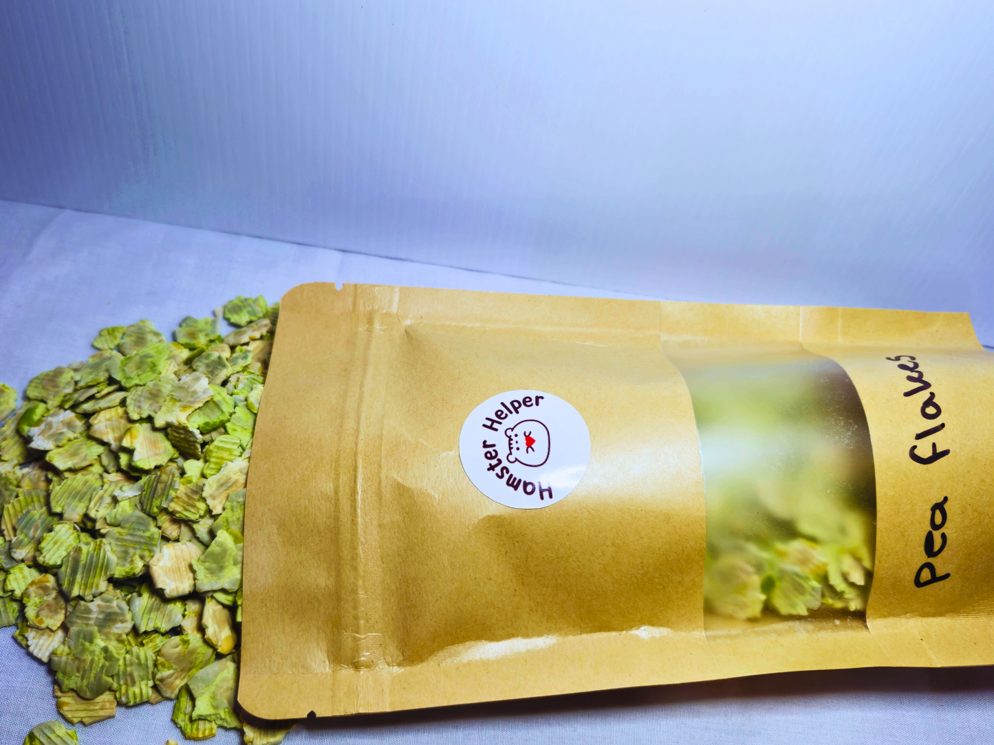 A large bag of pea flakes lying on its side with pea flakes spilling out of it.