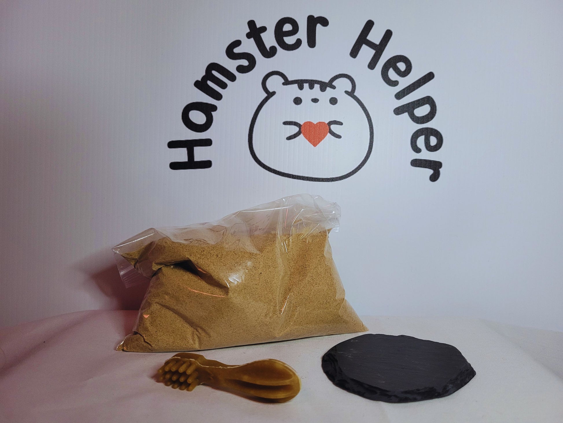 The small hamster grooming bundle containing a small slate, 500g of hamster safe sand and a small slate for nail maintenance