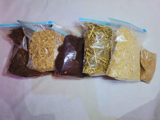 A bundle of hamster safe substrates lined up on a white background, from left to right: hamster safe coco chips, beech chips, hamster soil, hay, aspen bedding and hamster safe sand