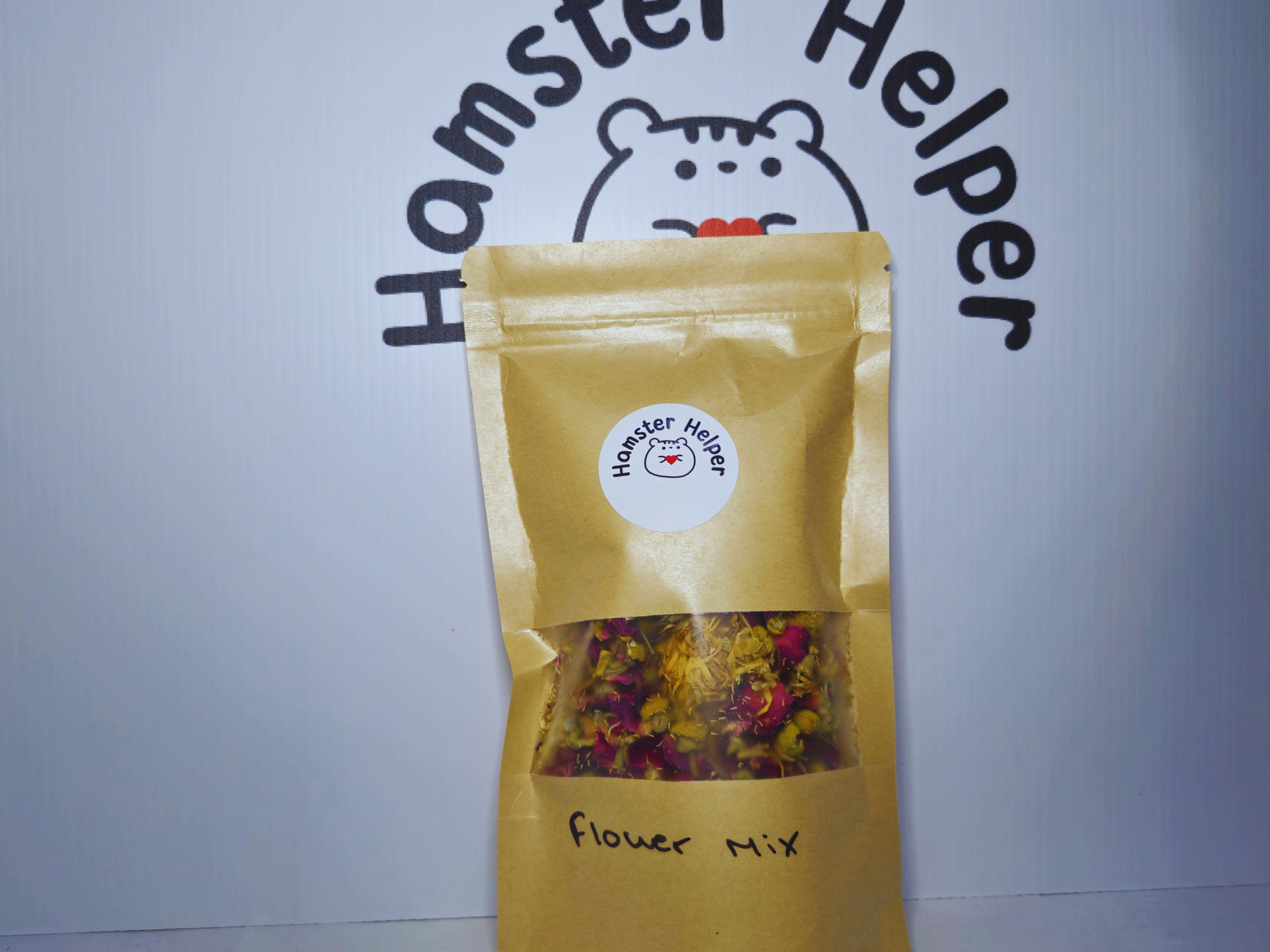 Hamster flower foraging mix in a pouch that says 'flower mix' and has a Hamster Helper sticker on it.