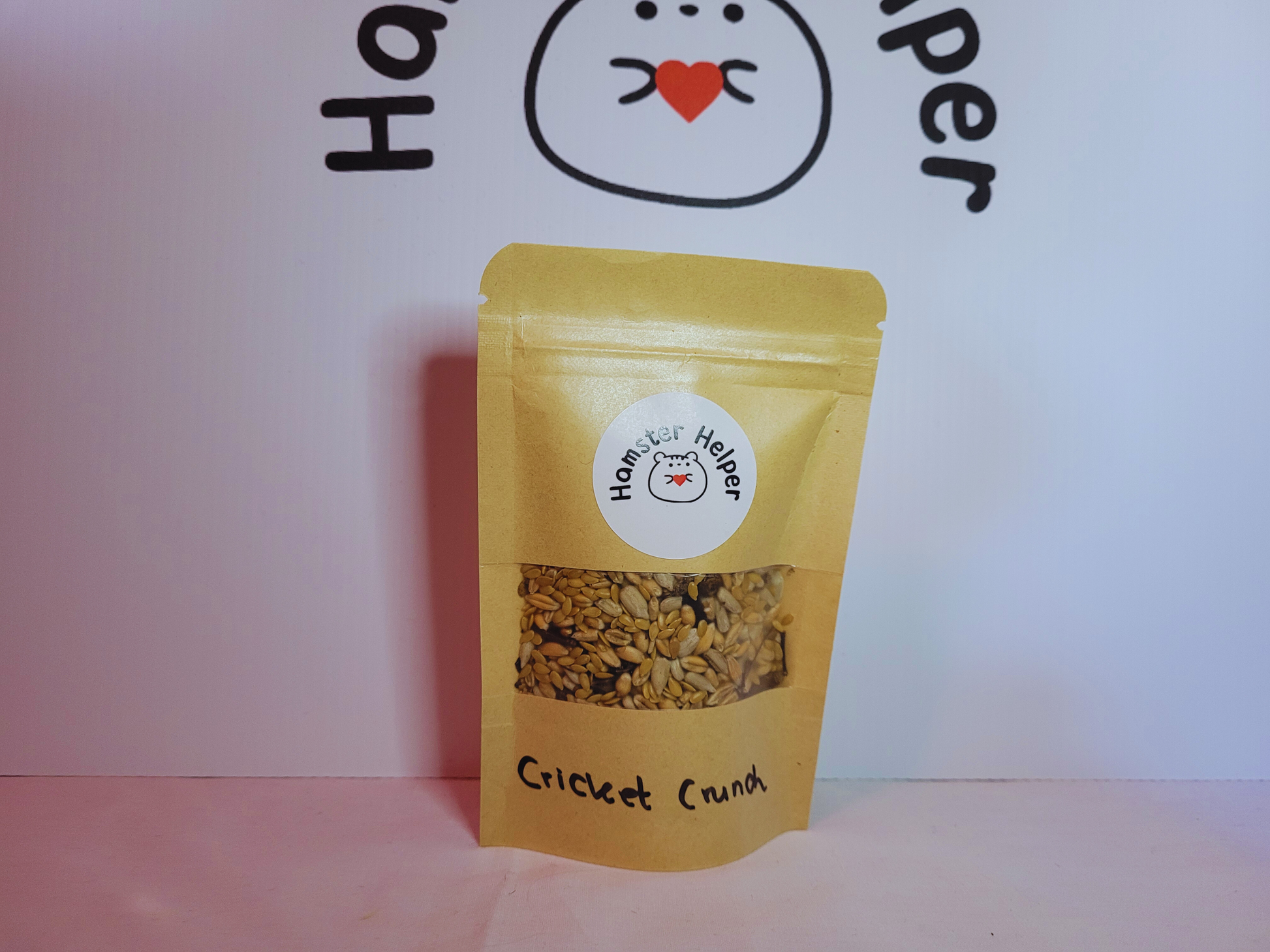 The cricket crunch treat mix in a small pouch with the Hamster Helper logo sticker on it.