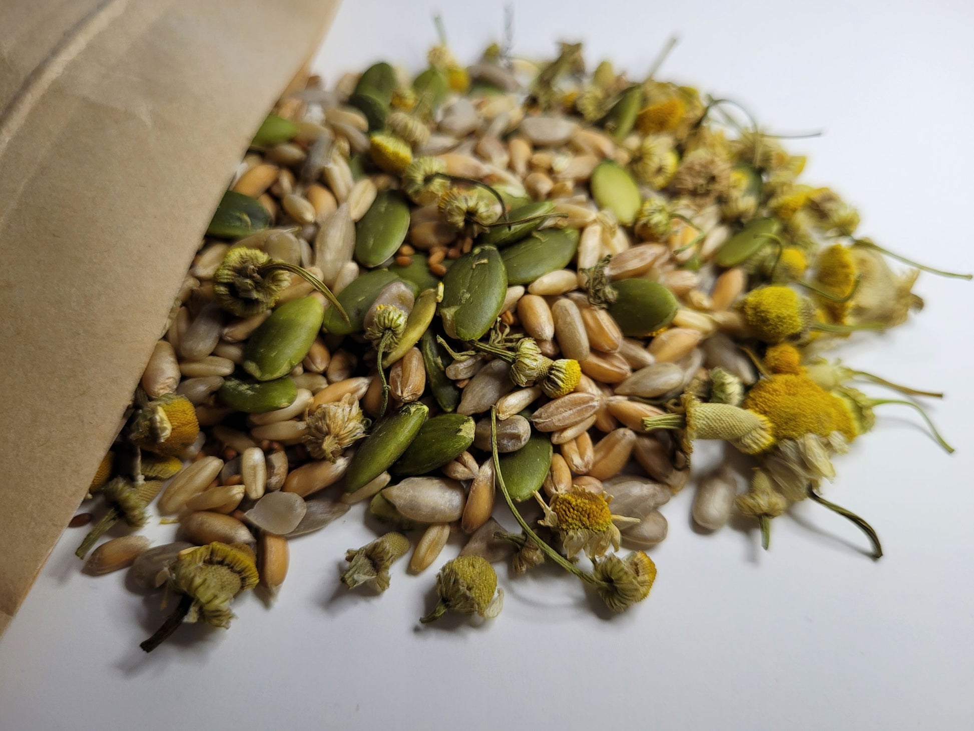 A close up of the chamomile charm crunch hamster treat mix showing that it contains chamomile grains and seeds